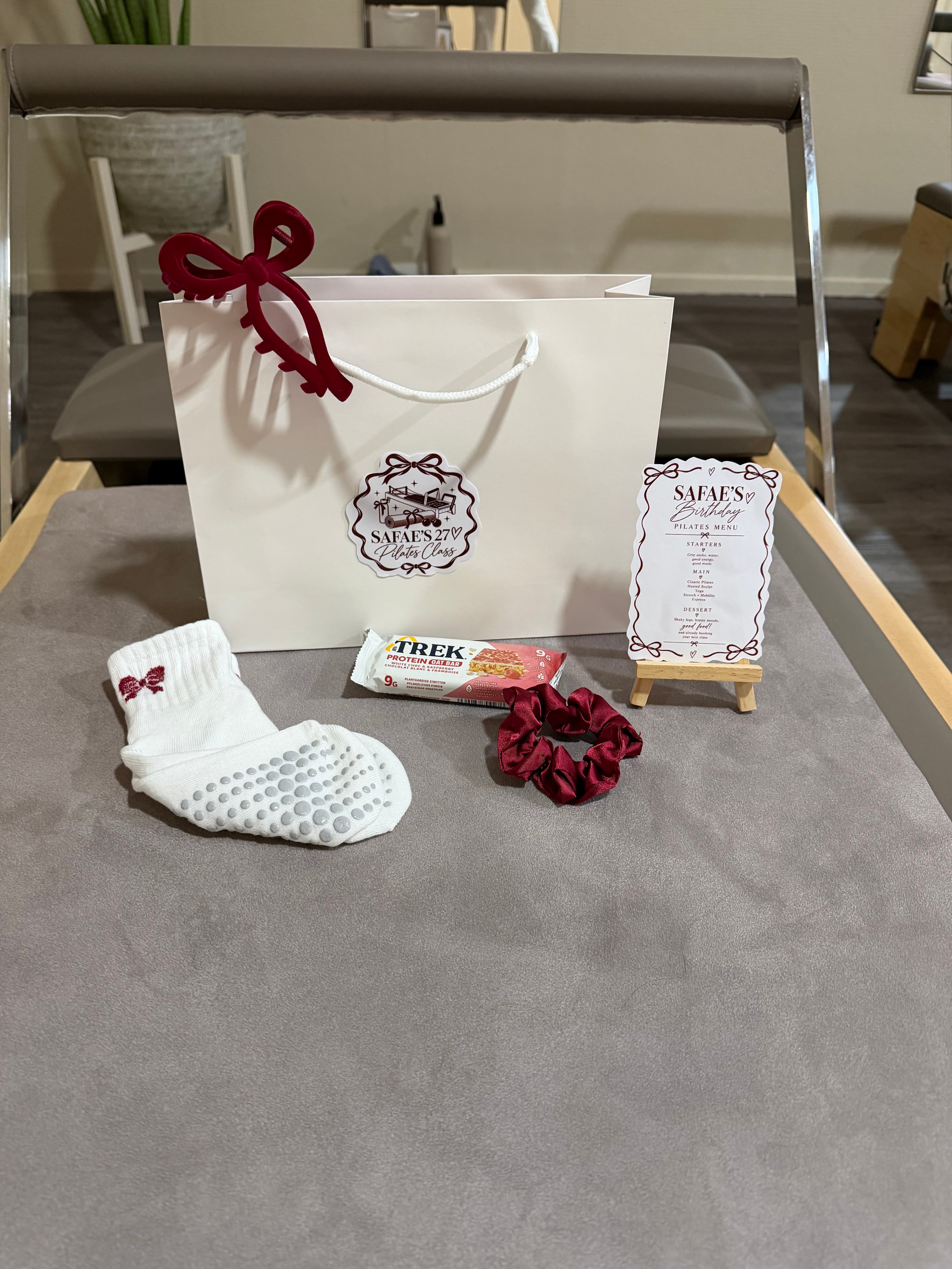 Goodie bag with grip socks and a scrunchie for a birthday class at aera pilates